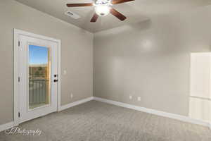 Spare room with carpet floors and a ceiling fan