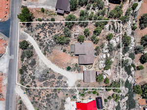 Aerial overview of property's location with property boundaries highlighted and a desert landscape