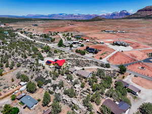 Aerial overview of property's location with a mountainous background and rural landscape