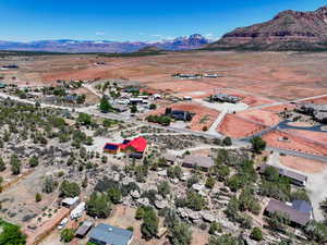 Aerial view of property and surrounding area with a mountainous background and rural landscape