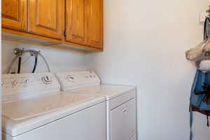 Laundry room featuring cabinet space and washer and dryer