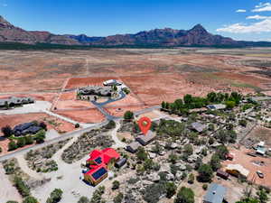 Aerial view of sparsely populated area featuring a desert landscape and a mountain backdrop