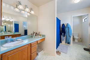 Full bath featuring marble look tile flooring and vanity