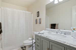 Full bath with vanity and curtained shower