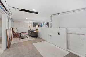 Laundry room with light carpet and recessed lighting