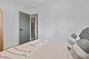 Bedroom featuring baseboards and arched walkways