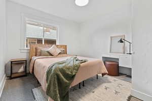 Carpeted bedroom featuring baseboards