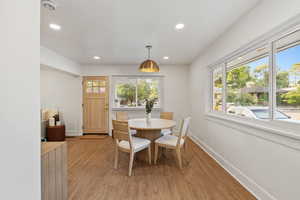 Dining space featuring healthy amount of natural light, light wood-type flooring, and recessed lighting