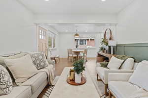 Living room featuring light wood-style flooring, healthy amount of natural light, and recessed lighting