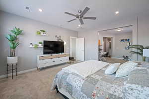 Bedroom with light colored carpet, recessed lighting, and ceiling fan