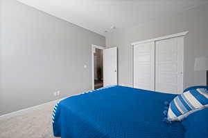 Bedroom featuring a closet and carpet flooring