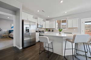 Kitchen featuring stainless steel appliances, healthy amount of natural light, white cabinets, and recessed lighting