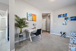 Carpeted office space featuring baseboards