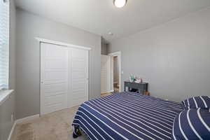 Bedroom featuring carpet floors and a closet
