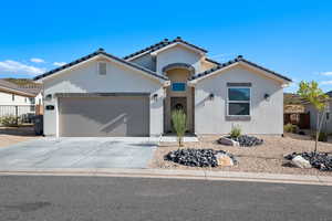 Mediterranean / spanish-style home featuring a garage, stucco siding, concrete driveway, and a tile roof