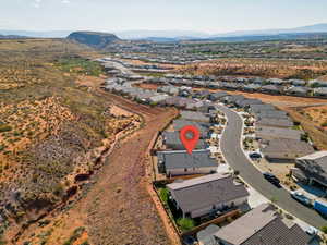 Aerial perspective of suburban area featuring a mountainous background