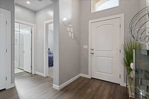 Entryway with dark wood-style flooring