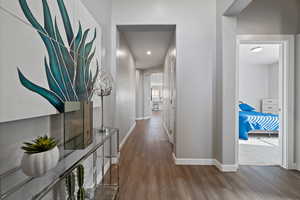Corridor featuring wood finished floors