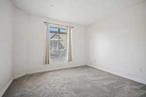 Unfurnished room with carpet flooring and baseboards