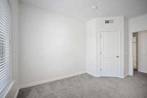 Unfurnished bedroom with carpet flooring