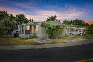 Manufactured / mobile home featuring driveway and an attached carport