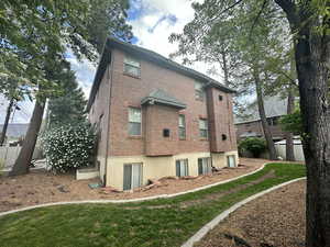 Rear view of property featuring brick siding