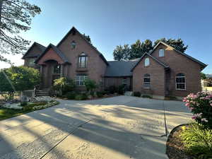 View of front of property with brick siding and driveway