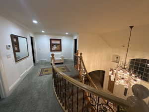 Hall featuring an upstairs landing, carpet, recessed lighting, a chandelier, and crown molding