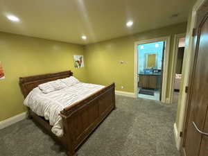 Bedroom featuring carpet flooring, recessed lighting, and connected bathroom