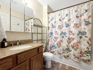 Full bathroom with vanity and shower / bath combo with shower curtain