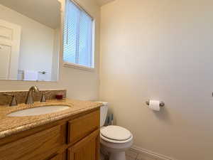 Half bath featuring vanity and tile patterned floors