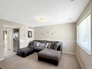 Living room featuring light colored carpet and baseboards