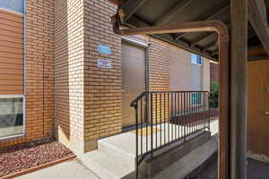 Property entrance featuring brick siding