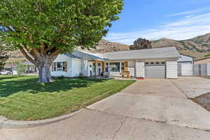 Single story home with a 1-car attached garage, 1-car detached garage and RV pad.