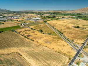 Aerial overview of property's location with rural landscape and a mountain backdrop