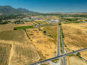 Aerial view of property and surrounding area with rural landscape and a mountainous background