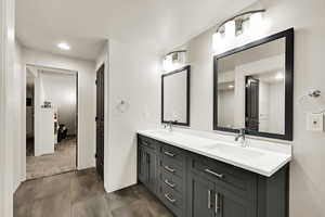 Full bathroom with double vanity and recessed lighting