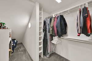 Walk in closet featuring carpet flooring