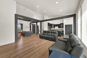 Living area featuring recessed lighting, light wood-style floors, and high vaulted ceiling