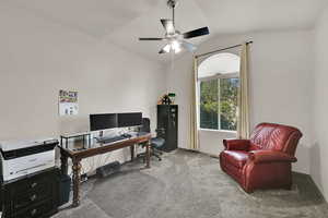 Office area featuring carpet, lofted ceiling, and ceiling fan
