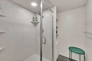 Bathroom featuring a stall shower and recessed lighting