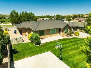 Rear view of property featuring a gate, stucco siding, a fenced backyard, and a patio