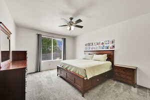 Bedroom featuring light carpet and a ceiling fan