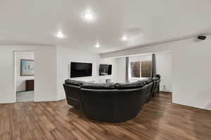 Living room featuring dark wood finished floors and recessed lighting