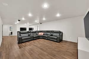 Living area with wood finished floors and recessed lighting