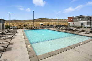 Community pool with a mountain view and a patio
