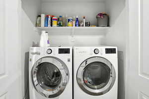 Laundry room with washing machine and clothes dryer