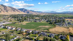 Aerial overview of property's location with nearby suburban area and mountains