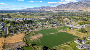 Aerial overview of property's location featuring mountains and nearby suburban area