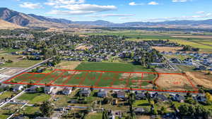 Aerial view of property's location featuring property parcel outlined and a mountain backdrop